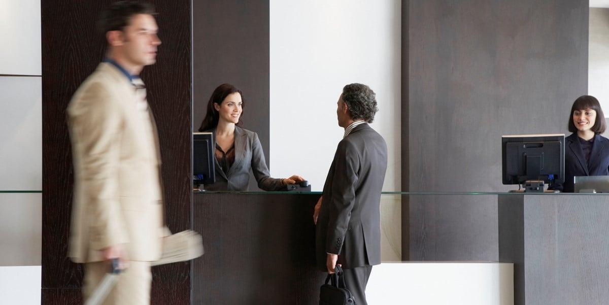 man at hotel checking in