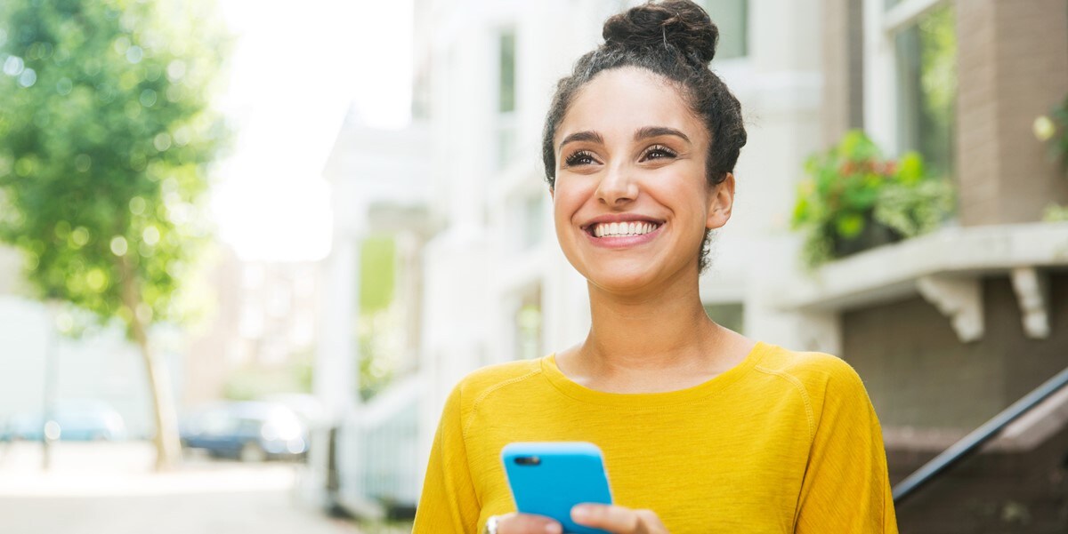 woman outside holding phone