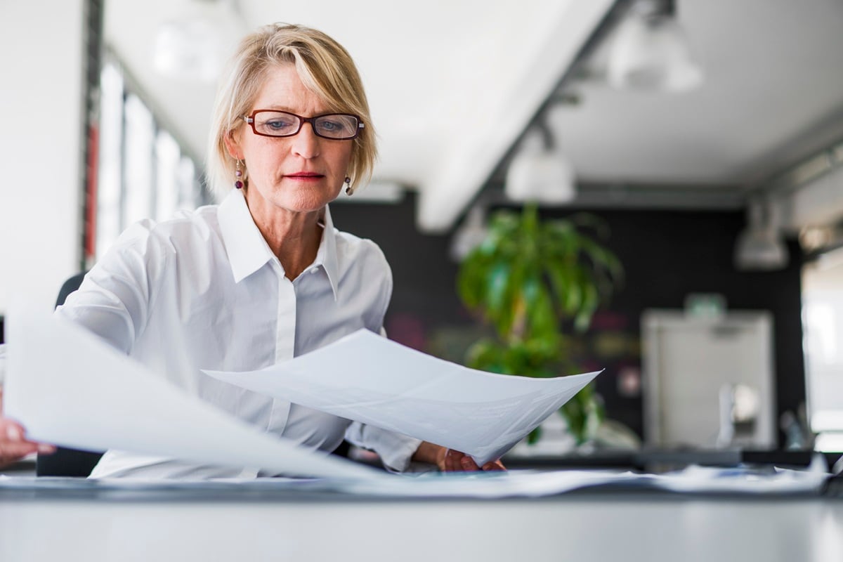 Lady sitting a desk with paper work