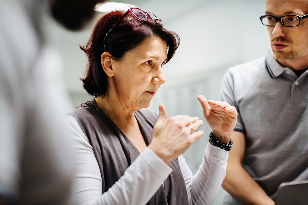 Lady with glasses in serious conversation 