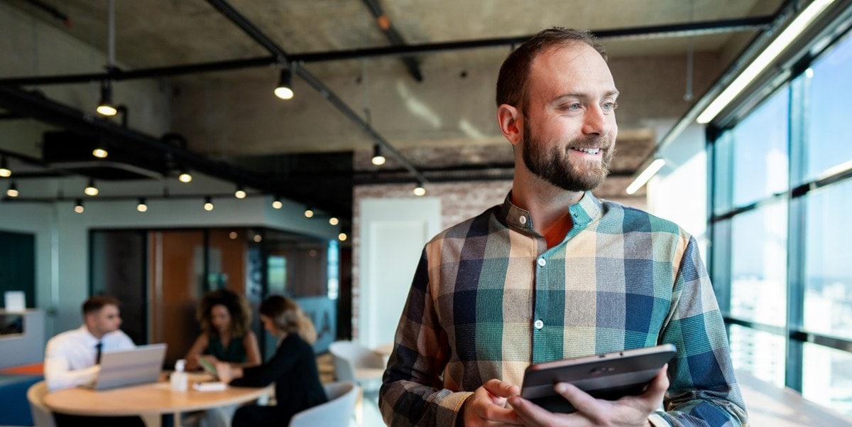 professional man in office holding tablet